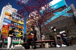 People wearing protetive masks amid an outbreak of the coronavirus are seen in front of Nakano station in Tokyo, Japan, March 5, 2020.