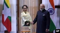 FILE - Myanmar State Counsellor Aung San Suu Kyi, left, and Indian Prime Minister Narendra Modi pose for the media ahead of their meeting in New Delhi, India, Jan. 24, 2018. 