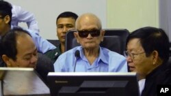 In this photo released by the Extraordinary Chambers in the Courts of Cambodia, Nuon Chea, center, who was the Khmer Rouge's chief ideologist and No. 2 leader, sits in the court room during a hearing at the U.N.-backed war crimes tribunal, in Phnom Penh, 