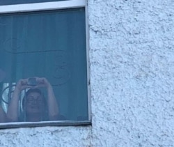 Aigul Utepova is seen in the window of a psychiatric clinic where a court ordered she be detained, in Kazakhstan’s capital, Nur-Sultan, on Nov. 23, 2020. (Courtesy: Togzhan Tuzel)