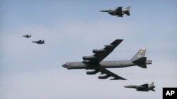 A U.S. Air Force B-52 bomber flies over Osan Air Base in Pyeongtaek, South Korea, Jan. 10, 2016. The bomber flew low over South Korea on Sunday, a show of force from the U.S. as a Cold War-style standoff deepened between ally Seoul and North Korea.