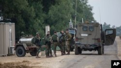 Israeli soldiers stand near the southern Israel-Gaza border, Nov. 12, 2018. Calm returned to the border after an Israeli special forces operation led to clashes that left eight people dead. 