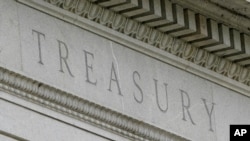 FILE - This May 4, 2021 file photo shows the Treasury Building in Washington. Nearly a year after the U.S. Treasury Department said it supports a global minimum corporate tax rate of at least 15%, Congress has been unable to pass legislation to implement it.