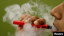FILE - In a national survey, just under 20% of high school students and 5% of middle school students said they were recent users of electronic cigarettes and other vaping products.