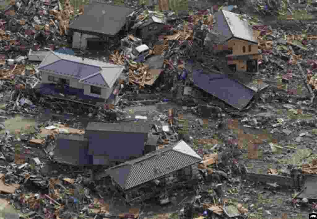 Debris covers part of a residential area in Rikuzentakata, northern Japan, Monday, March 14, 2011, three days after a powerful earthquake-triggered tsunami hit the country's east coast. (AP Photo/The Yomiuri Shimbun, Atsushi Taketazu) JAPAN OUT, CREDIT MA