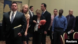 People wait in line to meet with recruiters during a job fair in Melville, New York July 19, 2012.