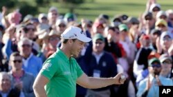 Danny Willett, of England, celebrates on the 18th hole after finishing the final round of the Masters golf tournament Sunday, April 10, 2016, in Augusta, Georgia. 