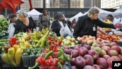 People buy fresh fruits and vegetables at an open-air farmers market in downtown Chicago. (AP Photo/M. Spencer Green)