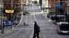 A man walks along the main road in the central business district of Sydney, June 26, 2021, as Australia's largest city entered a two-week lockdown to contain an outbreak of the highly contagious delta variant. 