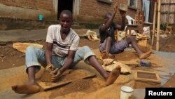 FILE - Artisanal miners crush tin ore before it is washed and then bagged ready for sale in Nyabibwe, a mining town in South Kivu, DRC.