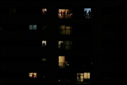 People applaud from their houses in support of the medical staff in Rivas Vaciamadrid, March 14, 2020.