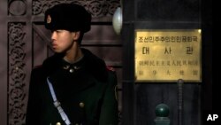 A Chinese paramilitary policeman stands guard outside the North Korean Embassy in Beijing, Jan. 6, 2016. 