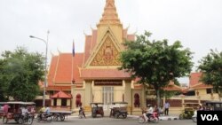 People gather at a makeshift memorial to observe a minute of silence to honor 84 people killed by a truck rampage on the famed Promenade des Anglais in Nice, southern France.