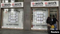 Young couple approaches an employment agency in Milan, Italy, April 2, 2012.