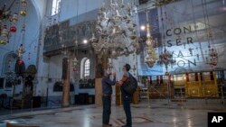 Tourists visit the Church of the Nativity, in the West Bank city of Bethlehem, Tuesday, Nov. 16, 2021. (AP Photo/Nasser Nasser)