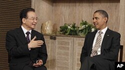 U.S. President Barack Obama meets with Chinese Premier Wen Jiabao on the sidelines of the East Asia Summit in Nusa Dua, in Bali, Indonesia, Saturday, Nov. 19, 2011.