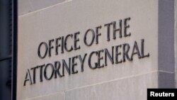 FILE - A sign of the Office of the Attorney General is displayed on the Department of Justice building the day after Special Counsel Robert Mueller delivered his report into Russia's role in the 2016 U.S. election, March 23, 2019. 