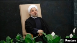 Iran's President Hassan Rouhani waits to address the 68th United Nations General Assembly at UN headquarters in New York, Sept. 24, 2013. 