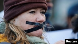 Demonstrators protest against the decision by public broadcaster the South African Broadcasting Corporation (SABC) that it would not broadcast scenes of violent protest, in Cape Town, South Africa, July 1, 2016.