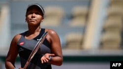 Japan's Naomi Osaka after winning against Romania's Patricia Maria Tig during their women's singles first round tennis match on Day 1 of The Roland Garros 2021 French Open tennis tournament in Paris on May 30, 2021. (Photo by MARTIN BUREAU / AFP)
