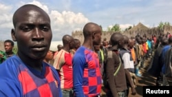 FILE - Congolese Mai-Mai rebels who surrendered their weapons to government officials stand in a formation in Kitchanga, in the Masisi territory of North Kivu province, in the Democratic Republic of Congo, June 21, 2021. 