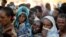 FILE - Ethiopian refugees line up for supplies at the Um Rakouba refugee camp, which houses refugees fleeing the fighting in the Tigray region, on the Sudan-Ethiopia border in Sudan, Nov. 29, 2020. 