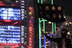 A pro-democracy protester takes part in a rally to support Spark Alliance, a fundraising platform that has been accused of money laundering and had its funds frozen by authorities, in Hong Kong on Dec. 23, 2019.