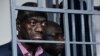 FILE - Ugandan four-time presidential aspirant Kizza Besigye stands in steel dock at Uganda Military General Court Martial in Kampala, Nov. 20, 2024. Besigye disappeared in neighboring Kenya and resurfaced later in a military court in Kampala.