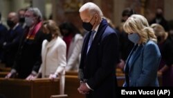  FILE - In this Wednesday, Jan. 20, 2021 file photo, President-elect Joe Biden and his wife, Jill Biden, attend Mass at the Cathedral of St. Matthew the Apostle during Inauguration Day ceremonies in Washington. (AP Photo/Evan Vucci, File)