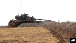 A Turkish tank is stationed near the Syrian border, in Karkamis, Turkey, Aug. 29, 2016. 