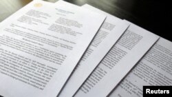 FILE - Attorney General William Barr's signature is seen at the end of his four-page letter to U.S. congressional leaders on the conclusions of Special Counsel Robert Mueller's report on Russian meddling in the 2016 election after the letter was released March 24, 2019.