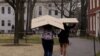 FILE - Students carry boxes to their dorms at Harvard University, after the school asked its students not to return to campus after Spring Break, March 10, 2020, in Cambridge, Massachusetts, U.S. 