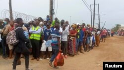 People wait for friends and relatives as a ship carrying more than 1,000 people fleeing an attack claimed by Islamic State-linked insurgents on the town of Palma, docks in Pemba, Mozambique, Apr. 1, 2021. 
