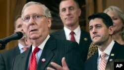FILE - Senate Majority Leader Mitch McConnell speaks on Capitol Hill in Washington, Dec. 8, 2016, with House Speaker Paul Ryan, right, looking on.