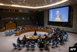 Special Coordinator for the Middle East Peace Process Tor Wennesland, on screen, speaks during a U.N. Security Council meeting, at U.N. Headquarters in New York City, Feb. 22, 2024.