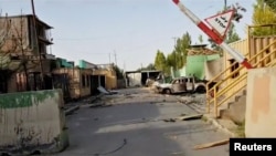 FILE - Damage is seen from a previous attack on a security base in Ghazni City, Afghanistan, in this still image taken from video by Ariana News, Aug. 13, 2018. Taliban insurgents attacked and overran a base outside the provincial capital Saturday. 