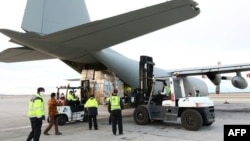 A handout picture released by the World Health Organization (WHO) on March 2, 2020, shows the unloading of medical equipment and coronavirus testing kits upon their arrival at Mehrabad International Airport in Iran's capital Tehran.