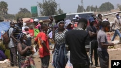 People are seen at a busy market in a poor township on the outskirts of the capital Harare, Nov, 15, 2021.