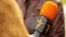 RFE/RL's Russian Service journalist with microphone during an interview undated