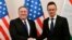 Hungarian Minister of Foreign Affairs and Trade Peter Szijjarto, right, shakes hands with US Secretary of State Mike Pompeo in the ministry in Budapest, Hungary, Feb. 11, 2019. 