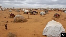 A child runs, left, at a refugee camp in Dadaab, Kenya, Aug 4, 2011.