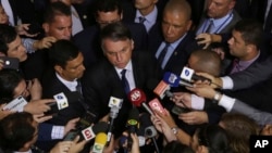 Brazil's President Jair Bolsonaro speaks to the press after signing a second decree that eases gun restrictions, at the Planalto presidential palace in Brasilia, Brazil, May 7, 2019. 