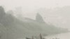 A man rows a boat on Siak River as thick haze from wildfires blanket the city in Pekanbaru, Riau province, Indonesia, Oct. 5, 2015. 