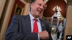 Rep. Dave Brat, R-Va., a member of the conservative House Freedom Caucus, speaks with a reporter just before passage of the Republican tax reform bill in the House of Representatives, on Capitol Hill, in Washington, Dec. 19, 2017.