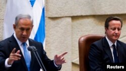 British Prime Minister David Cameron (R) listens as Israel's Prime Minister Benjamin Netanyahu delivers a speech at the Knesset, Israel's parliament, in Jerusalem, March 12, 2014.