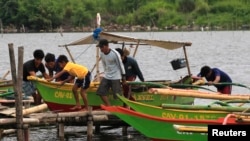 Warga bersiap menghadapi topan Rammasun (yang juga disebut Glenda oleh penduduk local), dengan mengamankan perahu-perahu mereka di wilayah pantai kota Cavite, selatan Manila (15/7).