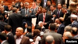 Members of the newly elected Iraqi parliament point fingers at each other after an argument broke out at the parliament headquarters in Baghdad July 1, 2014.