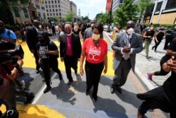 District of Columbia Mayor Muriel Bowser walks on the street leading to the White House after the words Black Lives Matter were painted in enormous bright yellow letters on the street by city workers and activists, June 5, 2020, in Washington.