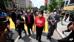 District of Columbia Mayor Muriel Bowser walks on the street leading to the White House after the words Black Lives Matter were painted in enormous bright yellow letters on the street by city workers and activists, June 5, 2020, in Washington.