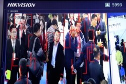 Visitors are tracked by facial recognition technology from state-owned surveillance equipment manufacturer Hikvision at the Security China 2018 expo in Beijing, China, October 23, 2018.